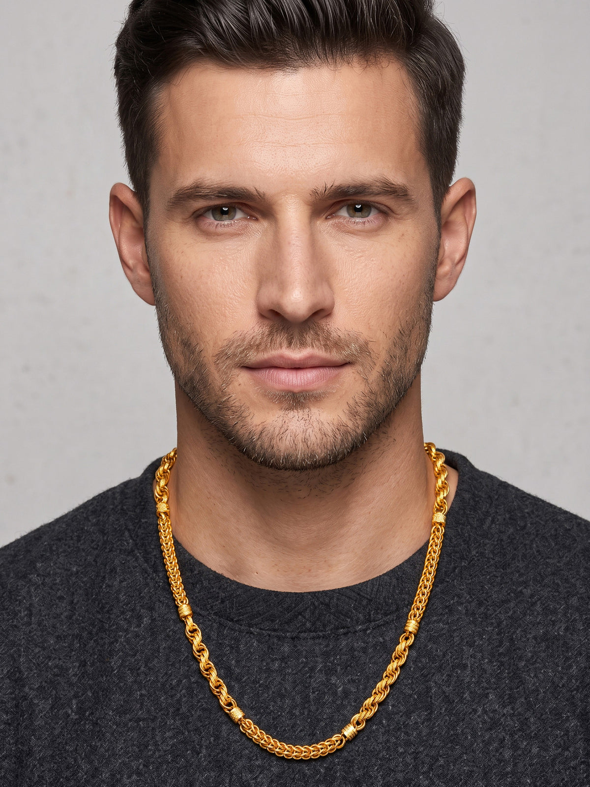 HOUSE OF JEWELLERY gold-plated brass zigzag chain with Nakshi finish worn by a man in a dark grey sweater